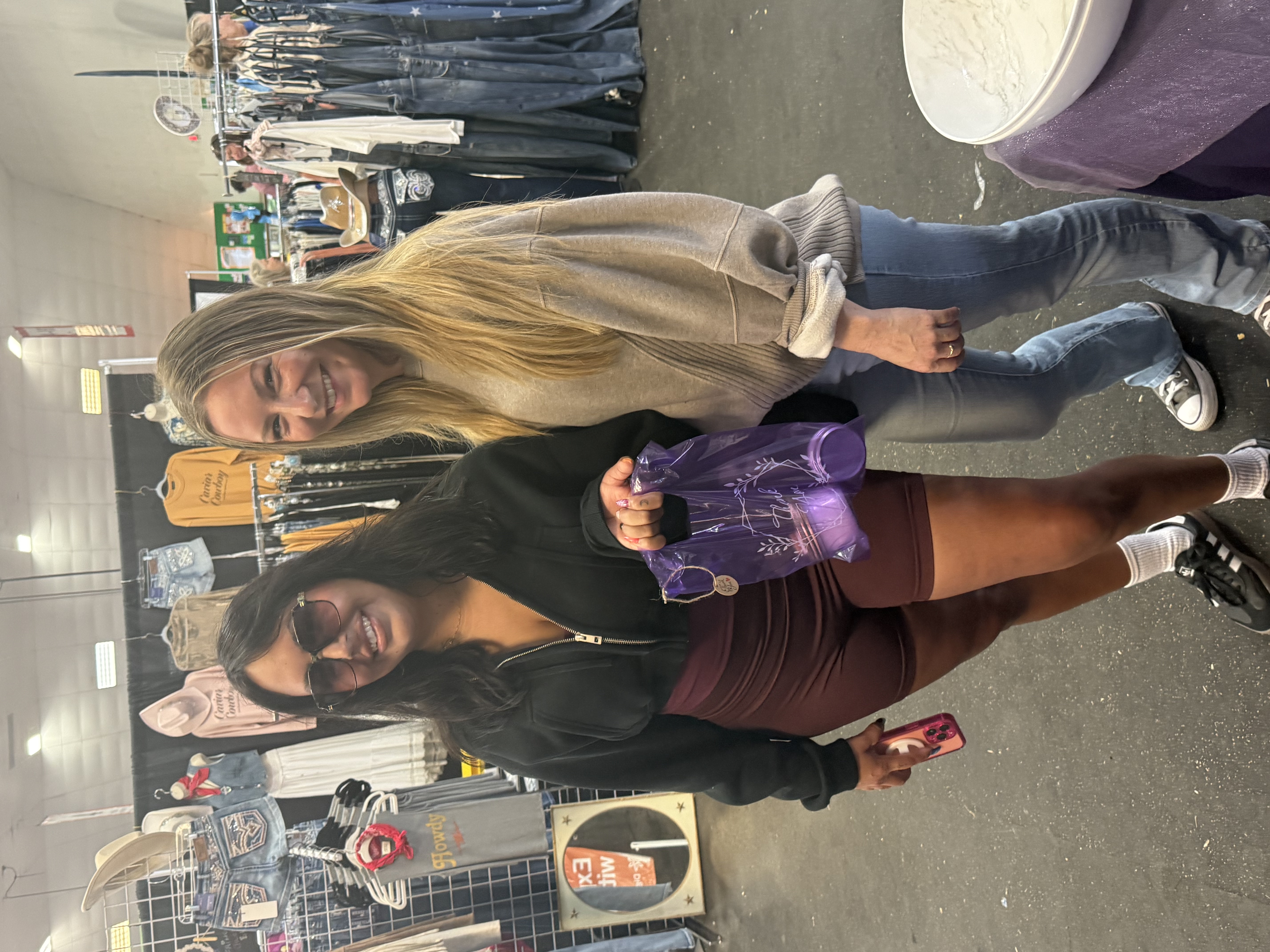 Two friends with Embrace Your Body bags after shopping the line.